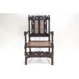 A Victorian carved elbow chair with caned seat and back, in 17th century style,