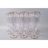 A set of twelve Murano champagne flutes with slight bell shaped bowls on baluster stems,