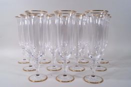 A set of twelve Murano champagne flutes with slight bell shaped bowls on baluster stems,