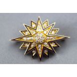 A yellow metal star brooch set with old cut diamonds, approx total weight of 1.25 carats.