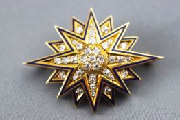 A yellow metal star brooch set with old cut diamonds, approx total weight of 1.25 carats.