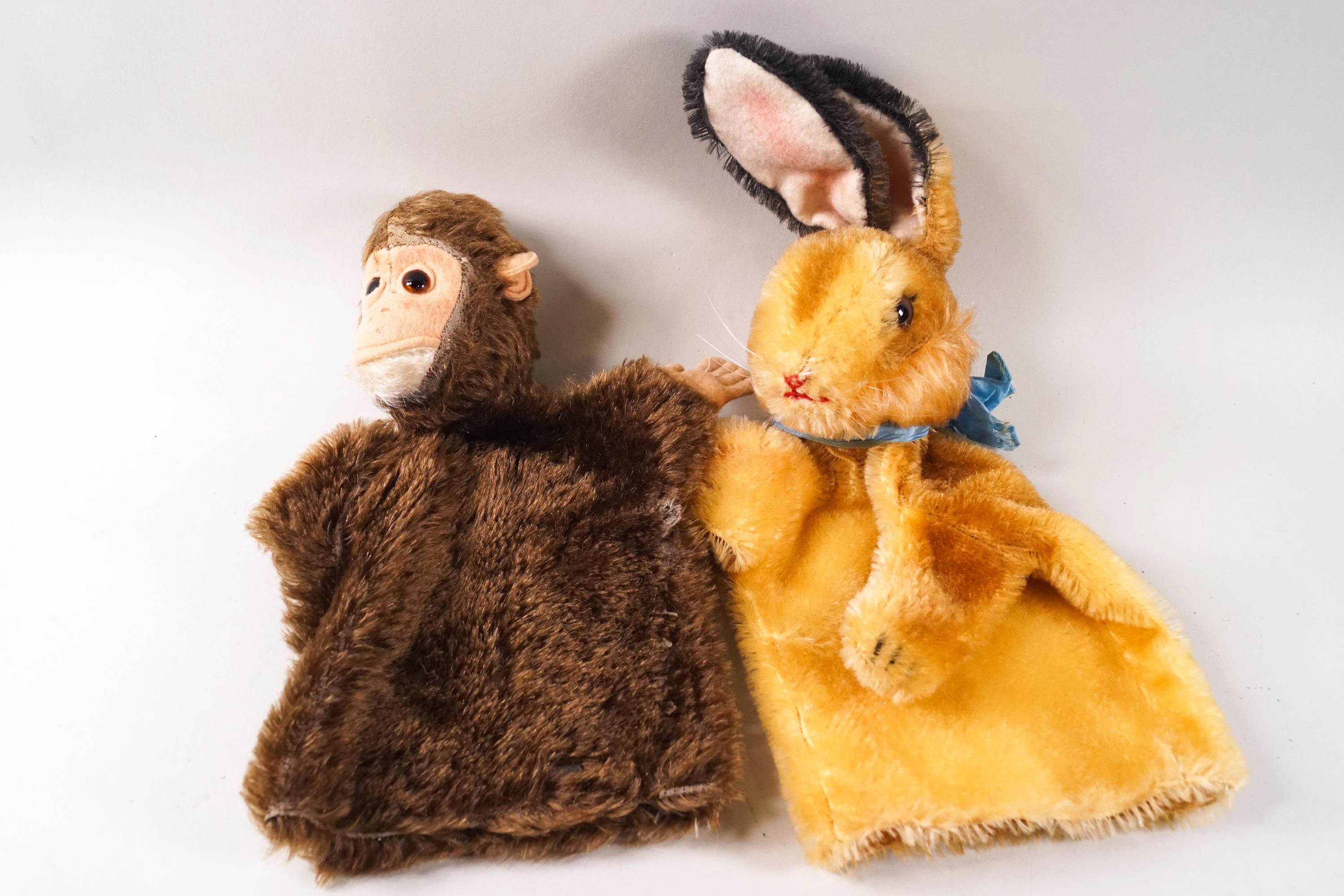 Two 1950's glove puppets by Kersa, in the form of a monkey, with factory metal tag,