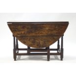 An elm oval gate leg drop leaf table