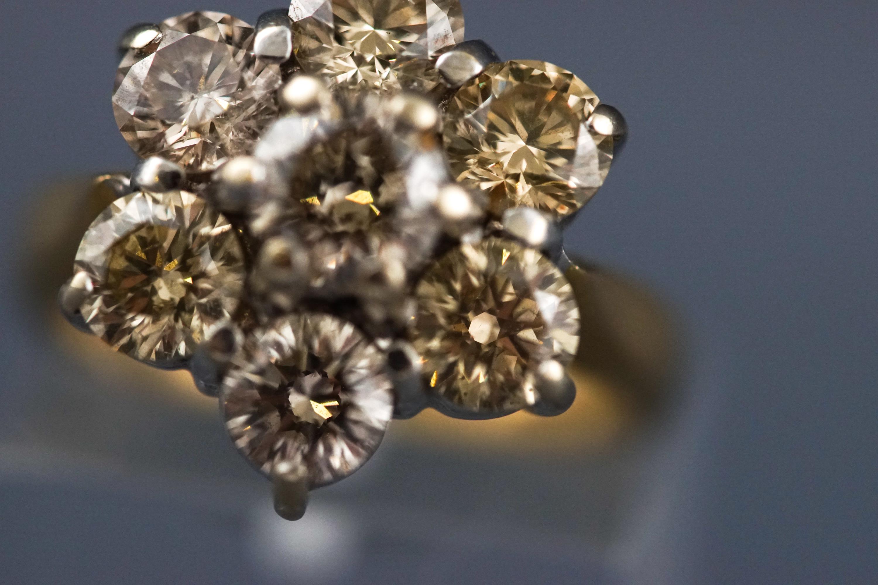 A yellow and white metal seven stone diamond flower ring, Estimated total weight of 2.50 carats. - Image 4 of 7
