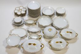 An extensive Limoges dinner service with gilt rims, together with eight Limoges oyster plates,