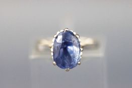 A white metal single stone ring set with an oval faceted cut sapphire approx 4.00 carats.
