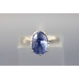 A white metal single stone ring set with an oval faceted cut sapphire approx 4.00 carats.