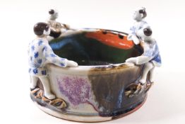 A 19th century Chinese porcelain bowl with figures peering over the rim,