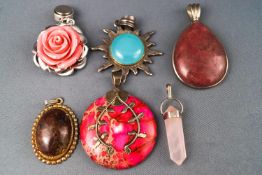 A selection of six pendants set with variable cabochon stones in sterling silver mounts.