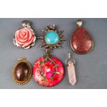 A selection of six pendants set with variable cabochon stones in sterling silver mounts.