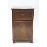 A 19th century mahogany cupboard with secretaire drawer over a panel doored cupboard