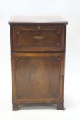 A 19th century mahogany cupboard with secretaire drawer over a panel doored cupboard