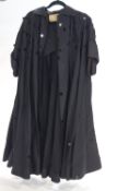 A ladies black evening coat with black circular disks,