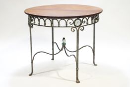 A metal base table of Empire form with round mahogany top,