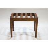 A mahogany luggage rack with square legs,