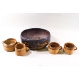 Three Studio pottery mugs and a matching milk jug together with a Studio pottery bowl.