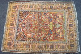 An antique Persian rug with central panel of a vase with flowers and birds,