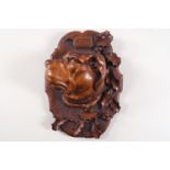 A 19th century Swiss carved wall plaque, the centre carved with a dogs head, titled 'Cesar',