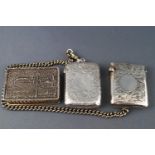 Two engraved silver vesta cases (one on a base metal chain), Birmingham 1915 and Birmingham 925,