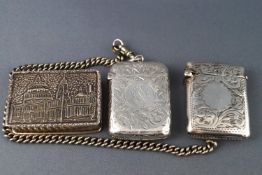 Two engraved silver vesta cases (one on a base metal chain), Birmingham 1915 and Birmingham 925,