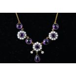 A yellow and white metal centrepiece necklace set with cabochon amethyst and seed pearls