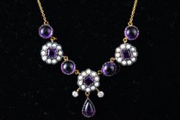 A yellow and white metal centrepiece necklace set with cabochon amethyst and seed pearls