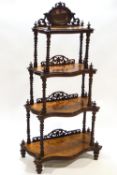 A Victorian walnut waterfall four tier what not,