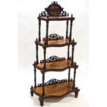 A Victorian walnut waterfall four tier what not,