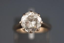 A white metal single stone diamond ring.