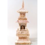 An early 20th century carved ivory temple with figure of a deity,