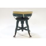 A piano style stool with upholstered cushion on blue painted legs with metal claw feet,