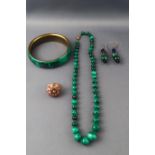 A gilt malachite bangle together with a malachite bead necklace,