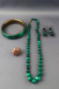 A gilt malachite bangle together with a malachite bead necklace,