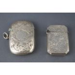 A silver vesta case with foliate engraving, Birmingham 1901 and another,