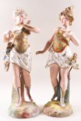 A pair of German porcelain bisque figures of ladies, one with wings, the other helmet and sword,