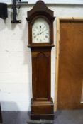 An 18th century oak long case clock with white painted arched dial to pillared hood enclosing an