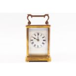 An early 20th century brass carriage clock striking on a gong, in leather travel case,