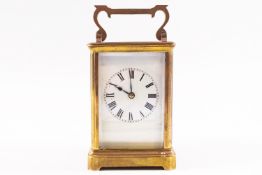 An early 20th century brass carriage clock striking on a gong, in leather travel case,