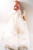 An Armand Marseilles baby doll, the bisque head with closing eyes and open mouth,