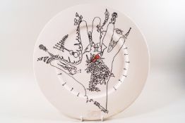 A Poole pottery plate decorated with a design by Uri Geller, applied factory mark.