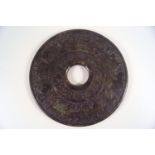 A Chinese green stone disc, carved with the Chinese Zodiac signs,