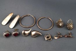 A selection of seven pairs of sterling silver earrings.
