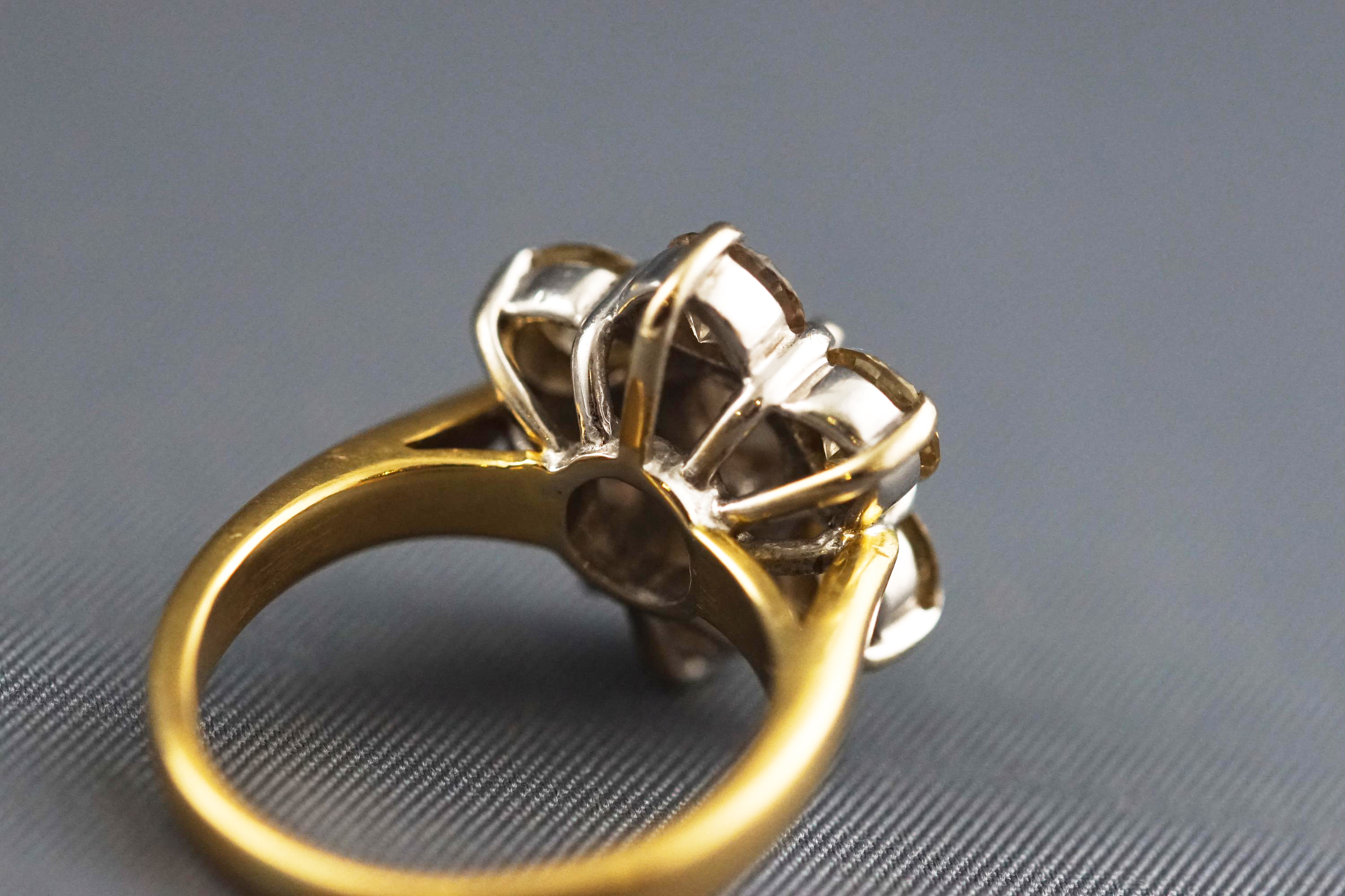 A yellow and white metal seven stone diamond flower ring, Estimated total weight of 2.50 carats. - Image 7 of 7
