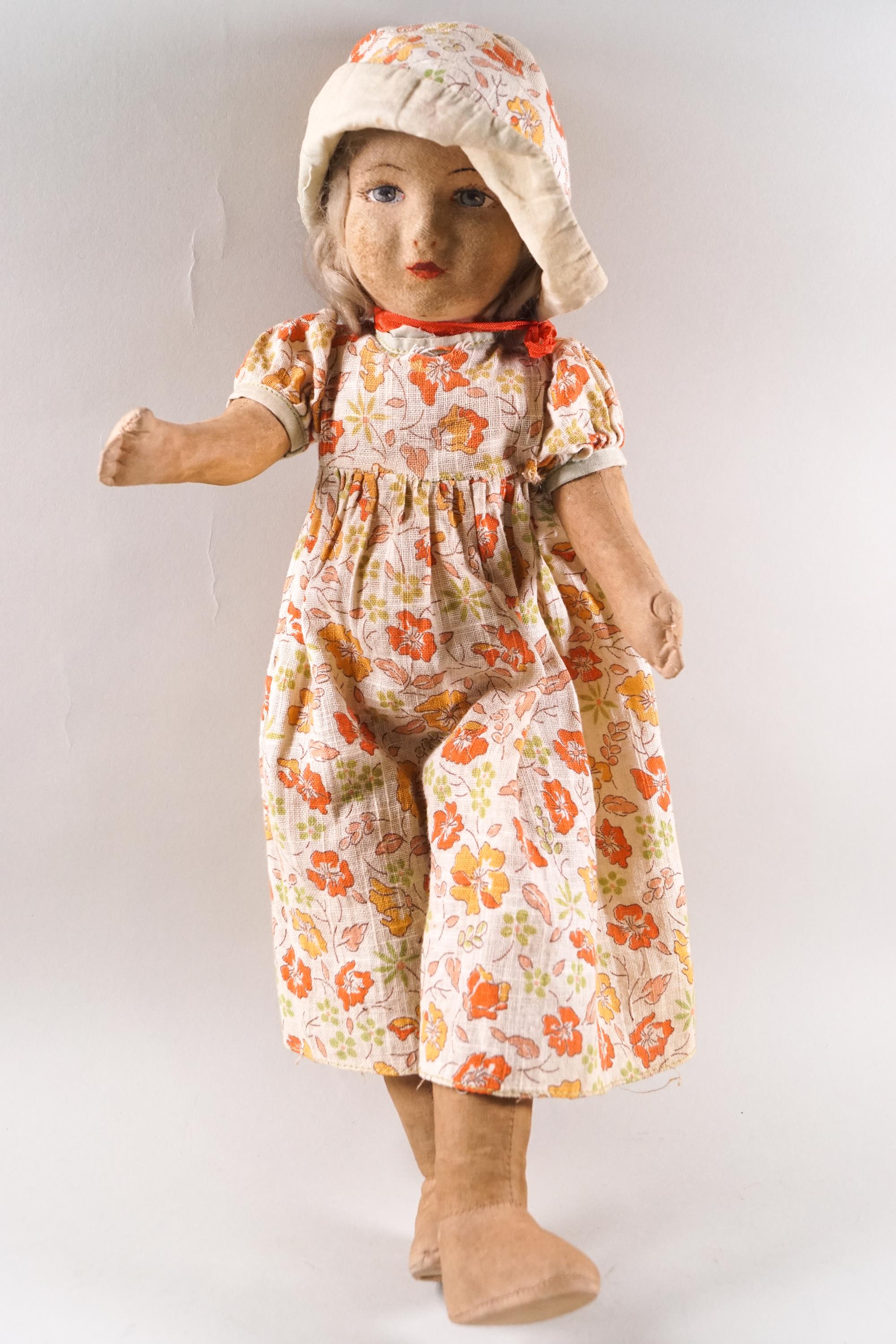 A Chad Valley doll, in the form of a young girl wearing a flower, hat and dress, 42cm high,