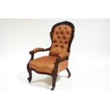 A Victorian mahogany show frame armchair with button back and carved cabriole legs
