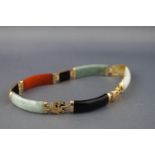 A panel bracelet designed as alternating coloured jade sections inter spaced with Chinese symbols.