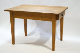 A 19th century pine kitchen table with one drawer on square tapering legs,