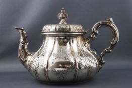 A silver baluster tea pot with panelled body, highlighted with strap work engraving, London 1873,