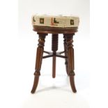 A Victorian mahogany revolving piano stool with upholstered seat