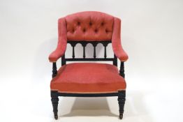 A Victorian nursing chair with button back and upholstered arms,